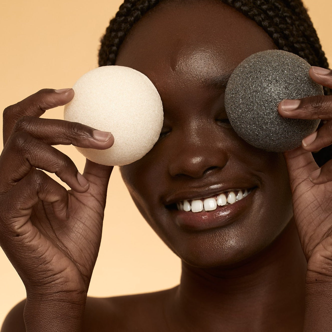 Woman cleansing face with konjac sponge